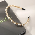 Elegant gold headband with white pearls and amber crystals on a black Vogue book background - Champagne Crystal Artificial Pearl Style