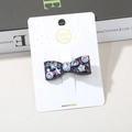 Handmade bow-shaped hair clip with colorful rhinestones on elegant white display card - Purple Bow Mixed Rhinestone