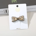 Bow hair clip with sparkling champagne rhinestones on a white display card - Champagne Bow Mixed Rhinestone