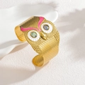 Detail view of owl face gold cuff with pink enamel and iridescent abalone shell eyes - Phantom Pink