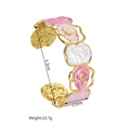 Detail view of镂空 hollow flower open bangle with pink enamel and hammered gold finish - Pink