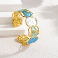 Golden open bangle with cutout rose flowers in blue, white and green enamel - Blue