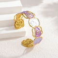 Detail of vintage gold open bangle featuring purple enamel roses and textured metal discs - Purple