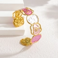 Detail view of pink and white enamel roses with hollow gold-plated metal on the cuff bangle - Pink