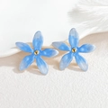 Detailed macro view of light blue five-petal flower stud earrings with golden center - Blue