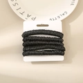 Set of 5 black silk satin hair scrunchies with elastic bands on a white display card - Black