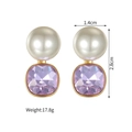 Detail view of pearl and purple zircon earrings with dimensions 1.4cm by 2.8cm - Gold