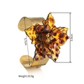 Macro shot of titanium steel cuff featuring a large amber leopard print flower detail - Leopard Flower (S-B1326-D)
