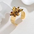 Detailed shot of golden leopard print flower cuff bracelet on white geometric props - Leopard Flower (S-B1326-C)