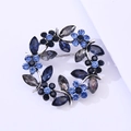 Detail of blue and grey crystal wreath brooch with intricate silver alloy prong setting - Vintage Silver Grey And Light Blue