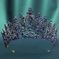 Detail of vintage gold crown with deep blue crystals on dark green fabric backdrop - KC Gold Dark Blue Crystal