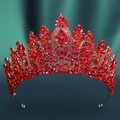 Macro shot of red crystals and golden leaves on a baroque bridal tiara crown - KC Gold Tone With Red Rhinestone