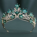 Close-up of baroque bridal crown with green crystals and floral rhinestone details - Gold Clear & Green Rhinestone Style