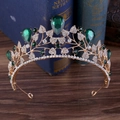 Golden baroque bridal crown with emeralds and rhinestones on a vintage book background - Gold Base With White And Green Rhinestone