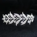 Detail view of bridal alloy crown with white rhinestones and leaf motifs on black velvet - Silver + White Zirconia
