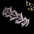 Close-up of alloy bridal crown featuring intricate rhinestone leaves and floral details - Rose Gold + Clear Zirconia
