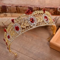 Dettaglio corona da sposa barocca dorata con rubini rossi e cristalli su libri d'epoca - Finto Oro 18K Cristallo Rosso
