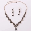 Detailed flat lay of a vintage gold alloy bridal jewelry set with grey rhinestones - Antique Gold Transparent Black Zircon Necklace + Earring Post