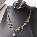 Close-up of luxury bridal gold necklace and drop earrings with sparkling teardrop zircons - KC Gold White Zircon Necklace + Ear Clip