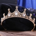 Close-up of golden bridal tiara with sparkling rhinestones and hollow wave patterns - KC Gold With White Rhinestones (H1147)