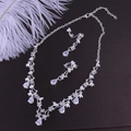 Macro detail of bridal jewelry set with silver necklace and pear-shaped zircon earrings - Thick Silver White Zirconia Ear Clip