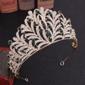 Detail of leaf rhinestone bridal crown with emerald green stones on a vintage background - KC Gold Green Rhinestone