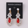 Macro detail of gold earrings with red marquise stone and white rhinestones on card - KC Gold Red Rhinestone (Post)