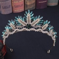 Detail of vintage gold crown with emerald green crystals and leaf patterns - Gold with Green Rhinestones