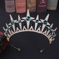 Close-up of a vintage gold star bridal crown with green gems and white rhinestones - Gold with Green Rhinestones