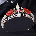 Close-up of golden bridal crown featuring red crystal peacock wings and white pearls - Gold with Red Rhinestones