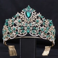 Detailed close-up of Baroque crown with emerald crystals and gold leaf patterns - KC Gold White + Green (Comb)