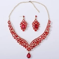Detailed macro view of bridal jewelry set with red teardrop crystals and gold finish - Gold Tone All Red Rhinestone