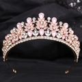 Close-up of golden alloy tiara featuring pink teardrop crystals and sparkling rhinestones - KC Gold White & Pink Jelly Rhinestone