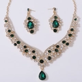 Detailed view of bridal jewelry set with green teardrop crystals and gold plating - Gold Tone White And Green Rhinestone