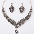 Detailed flat lay of bridal jewelry set with grey teardrop crystals in antique gold - Antique Gold Tone All Black Rhinestone