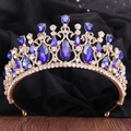 Detailed macro view of baroque gold tiara with blue gemstones and clear crystals - KC Gold White & Sapphire Blue Rhinestone