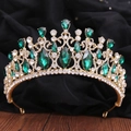Detail of baroque gold crown featuring emerald green crystals and sparkling rhinestones - KC Gold White Diamond + Green Diamond