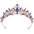 Detail of vintage golden bridal crown with blue teardrop gemstone and leaf pattern - KC Gold Clear and Blue Rhinestone