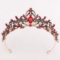 Close-up of golden crown with red teardrop rhinestones and black crystal accents - Antique Gold Black Diamond + Red Diamond