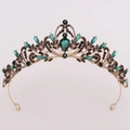 Close-up of golden crown featuring emerald green gems and black crystals for bridal wear - Antique Gold Black Diamond + Green Diamond