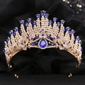 Detailed close-up of a gold baroque crown featuring sparkling blue crystals on black fabric - KC Gold Clear and Blue Rhinestone
