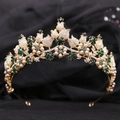 Close-up of golden bridal crown with emerald green crystals and cream pearls - KC Gold White Diamond + Green Diamond