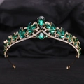 Detail shot of luxury gold bridal crown with deep green emerald stones on black velvet - KC Gold White Diamond + Green Diamond
