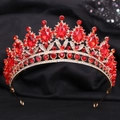 Close-up of red crystals and rubies on a gold leaf bridal crown for wedding hair - Handmade / Gold Red Zirconia
