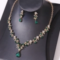 Detail of bridal jewelry set with green teardrop crystals and gold flower necklace - Gold Green Zirconia