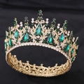 Close-up of gold baroque crown with emerald green crystals and sparkling diamonds - KC Gold White Diamond + Green Diamond
