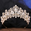 Close-up of golden baroque crown with sparkling crystals and elegant white pearls - Gold & White Rhinestone