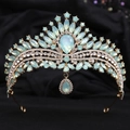 Close-up of a bridal crown with light blue crystals and golden alloy base on black velvet - KC Gold White & Green Jelly Rhinestone