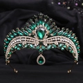 Detailed macro shot of vintage gold crown with emerald green teardrop crystals - KC Gold White With Olive Green Rhinestone