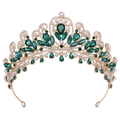 Detailed view of luxury gold bridal crown with emerald crystals and white faux pearls - Gold & Green Rhinestone